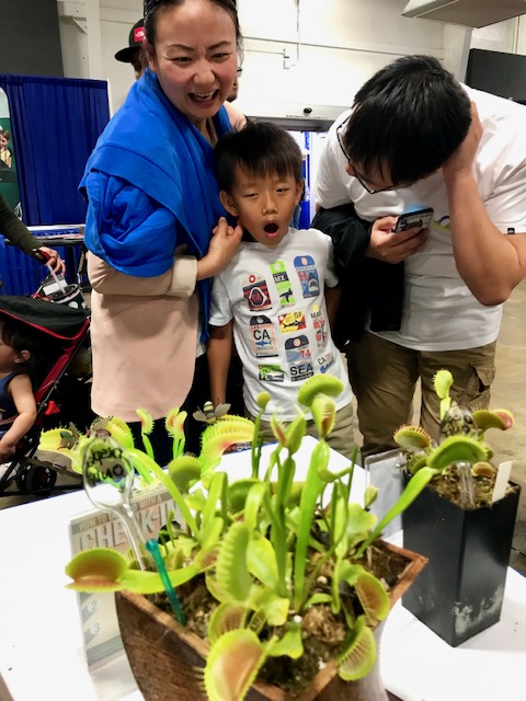 Visitors at the Los Angeles Carnivorous Plant Society booth at the Orange County Pet Expo